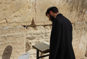 Jewish man praying at the wailing wall